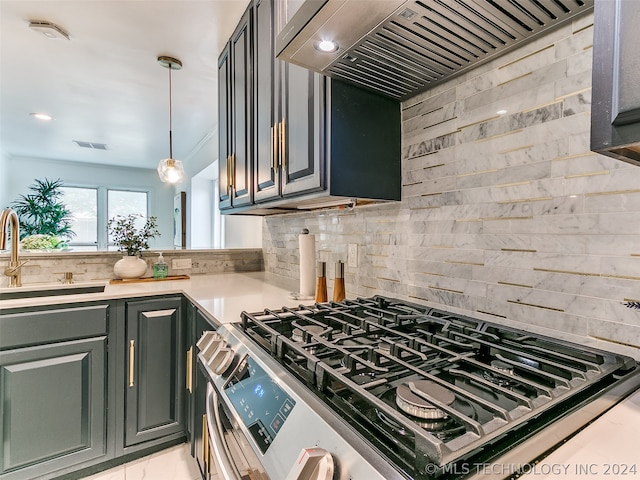 kitchen with range, sink, backsplash, decorative light fixtures, and premium range hood