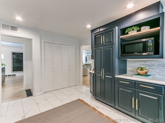 kitchen featuring stainless steel microwave and light tile floors