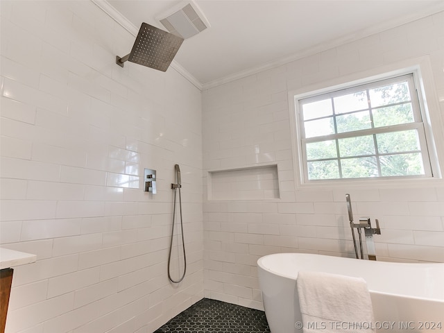 bathroom with plenty of natural light, vanity, tile floors, and tile walls