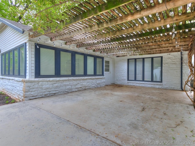 view of side of home with a patio and a pergola