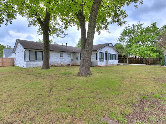 rear view of house with a lawn