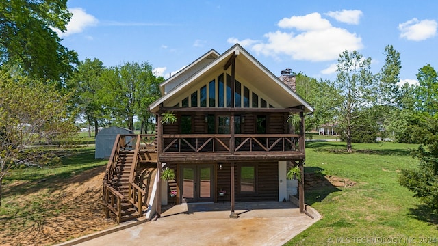 back of house with a patio area, a wooden deck, and a lawn