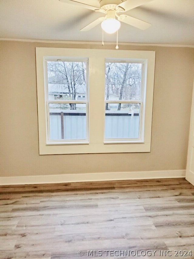 spare room with wood-type flooring and ceiling fan