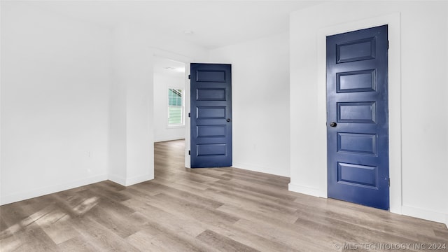 spare room featuring wood-type flooring