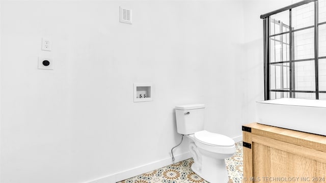 bathroom featuring vanity, tile floors, and toilet