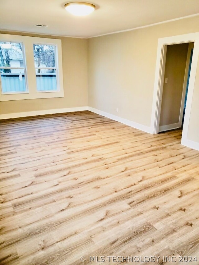 spare room featuring light wood-type flooring