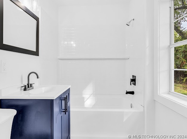 full bathroom featuring vanity, toilet, and shower / washtub combination