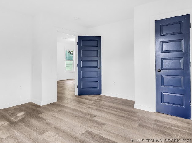 unfurnished room with hardwood / wood-style floors