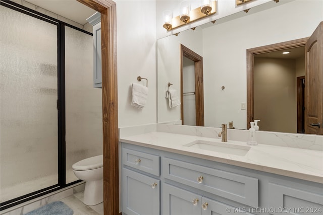 bathroom with an enclosed shower, toilet, vanity with extensive cabinet space, and tile flooring