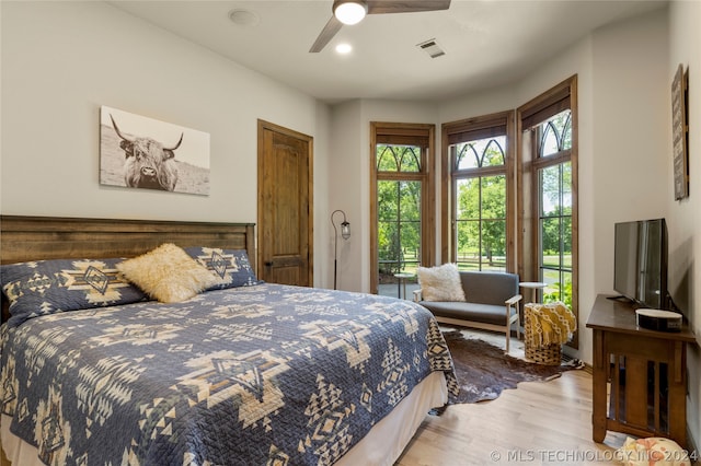 bedroom with ceiling fan and light hardwood / wood-style floors