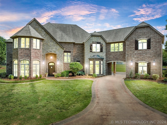 french country style house featuring a yard