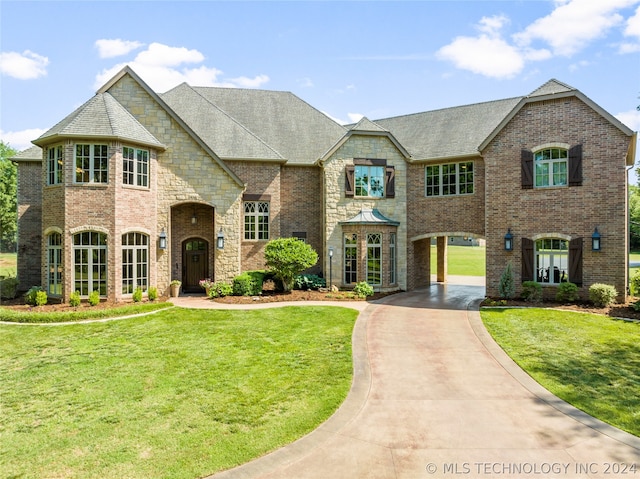 french country style house with a front lawn