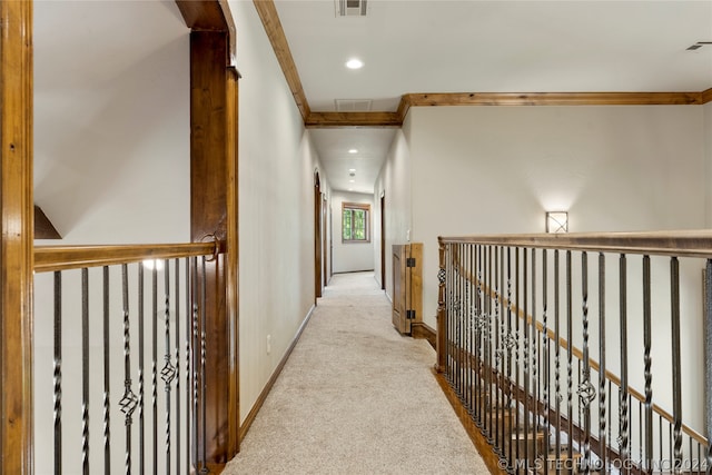 hall featuring ornamental molding and light colored carpet