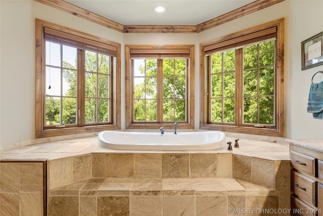 bathroom featuring ornamental molding, a relaxing tiled bath, and vanity