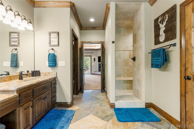 bathroom with ornamental molding, vanity, tiled shower, and tile flooring