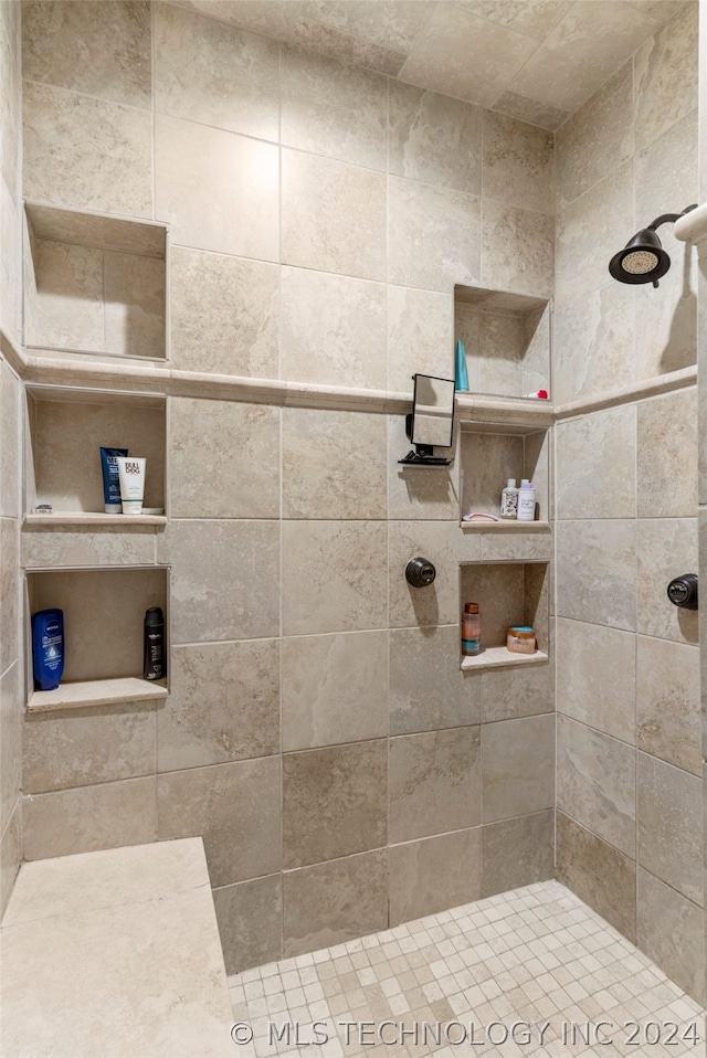 bathroom with a tile shower