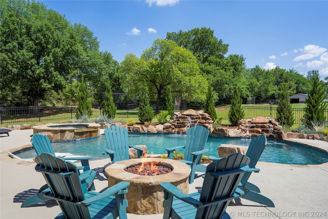 view of swimming pool featuring an outdoor fire pit, an in ground hot tub, and pool water feature