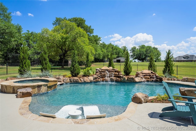 view of pool with pool water feature and an in ground hot tub