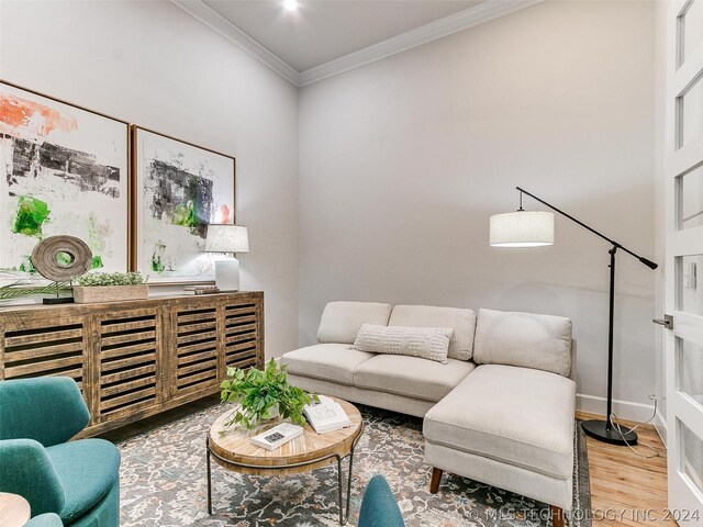 living room with ornamental molding and wood-type flooring