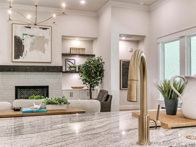 dining space featuring ornamental molding and a brick fireplace