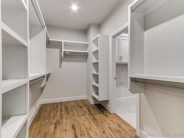 walk in closet featuring light hardwood / wood-style flooring