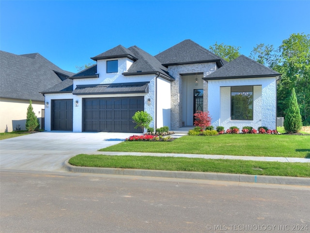 view of front of home with a garage and a front yard