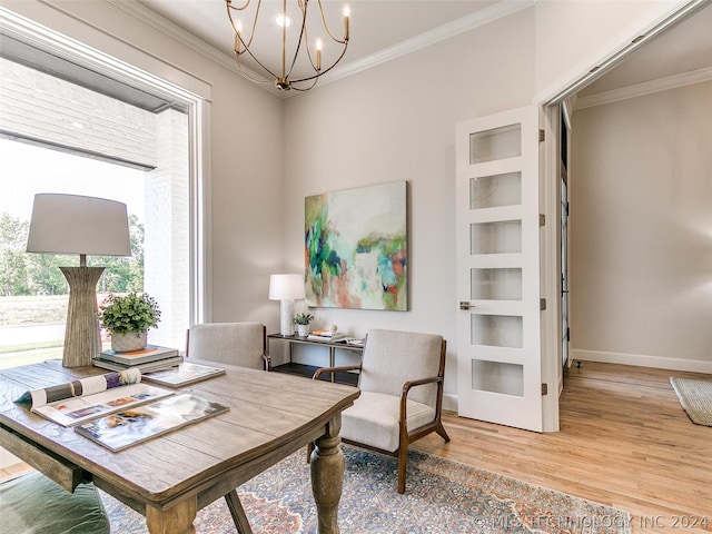 sitting room featuring hardwood / wood-style flooring, ornamental molding, and a chandelier