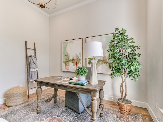 office area with crown molding, a chandelier, and wood-type flooring