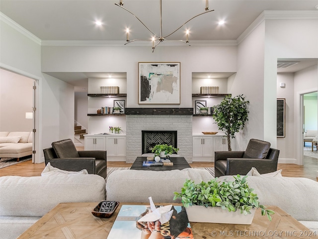 living room with crown molding, light hardwood / wood-style floors, and a fireplace