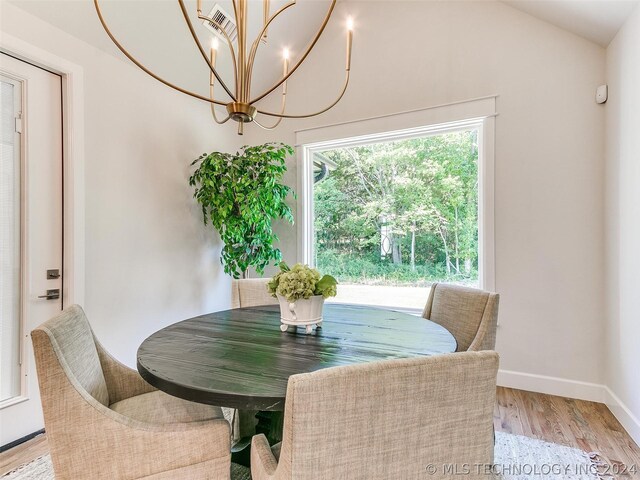 dining space featuring an inviting chandelier and light hardwood / wood-style flooring