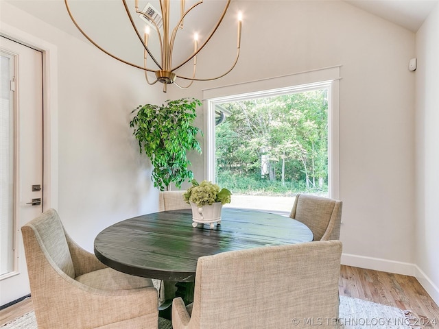 dining space with lofted ceiling and light hardwood / wood-style flooring