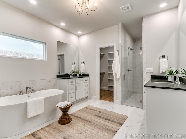 bathroom featuring wood-type flooring, vanity, a chandelier, and plus walk in shower