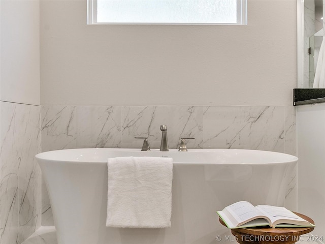 bathroom featuring a bathing tub and sink