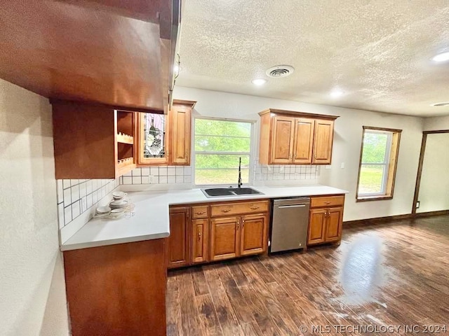 kitchen featuring backsplash, sink, a healthy amount of sunlight, and dishwasher