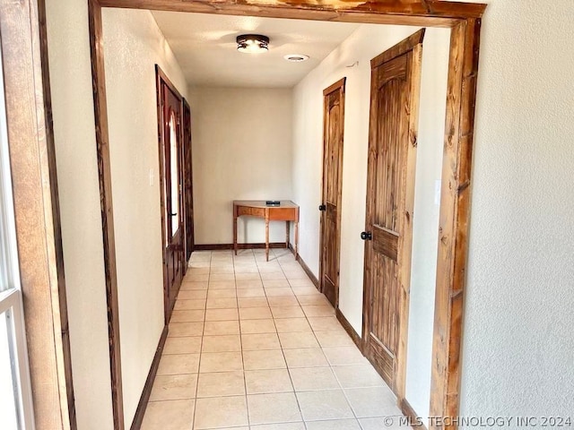 hallway featuring light tile patterned floors