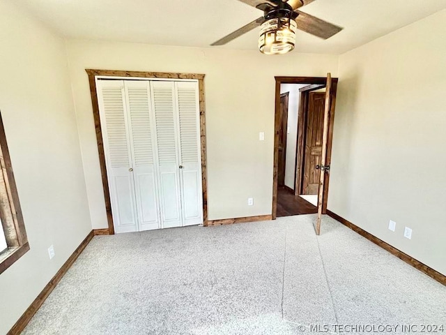 unfurnished bedroom featuring ceiling fan, a closet, and carpet