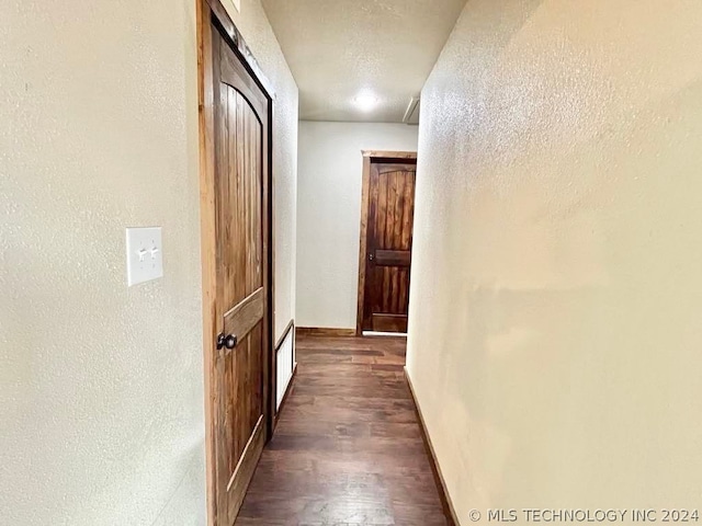 corridor featuring dark wood-type flooring