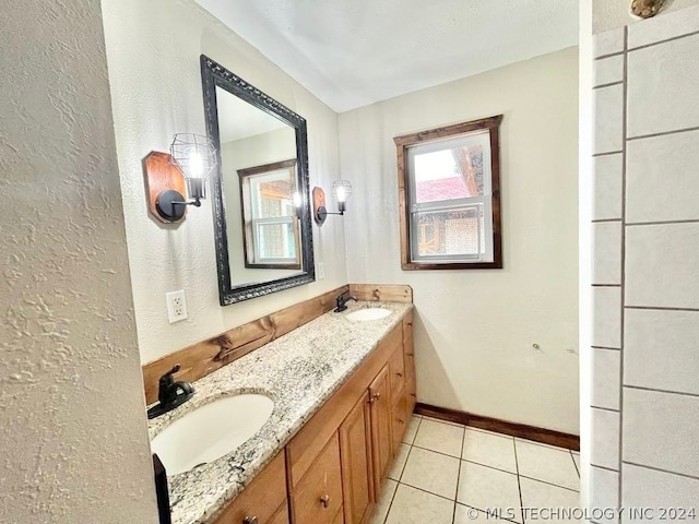 bathroom with tile patterned flooring and dual vanity