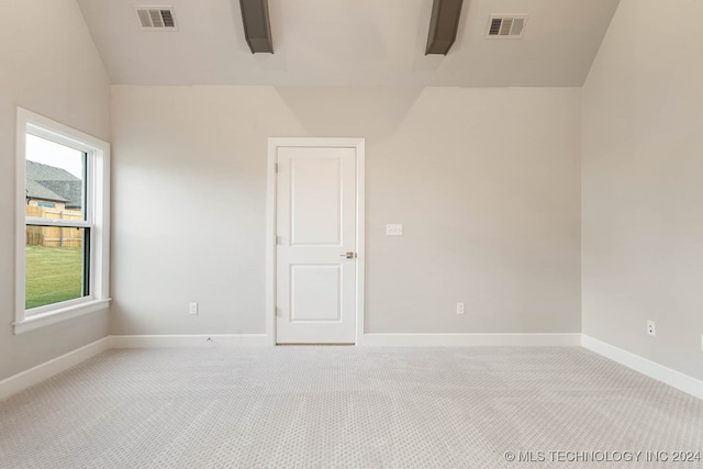 empty room with light carpet and lofted ceiling