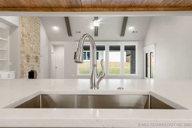 interior details with ceiling fan, beam ceiling, and wooden ceiling