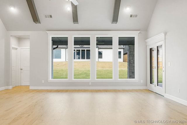 spare room with vaulted ceiling with beams, light hardwood / wood-style flooring, and ceiling fan