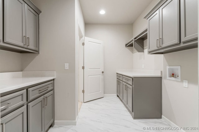 washroom with cabinets and hookup for a washing machine