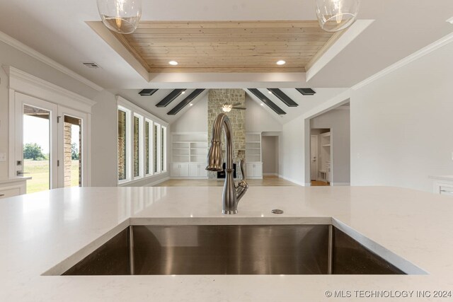 kitchen with ornamental molding, lofted ceiling, sink, and wooden ceiling