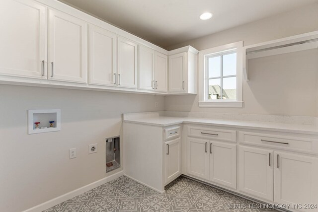 washroom featuring hookup for a washing machine, cabinets, and hookup for an electric dryer