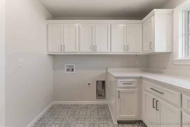 washroom featuring hookup for a washing machine, cabinets, and electric dryer hookup