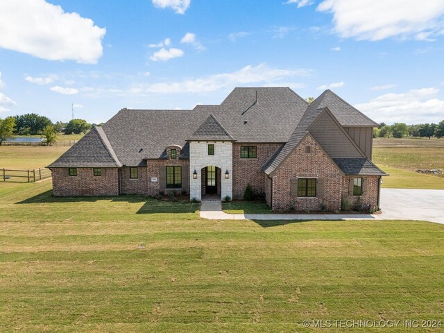 french country style house with a front yard