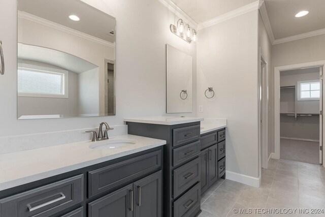 bathroom with ornamental molding, vanity, and tile patterned floors