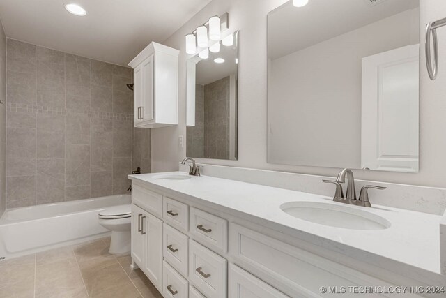 full bathroom featuring tile patterned flooring, vanity, toilet, and tiled shower / bath combo