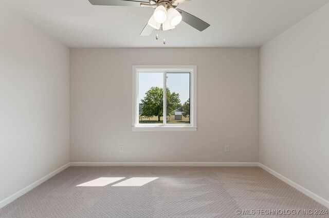 carpeted empty room featuring ceiling fan