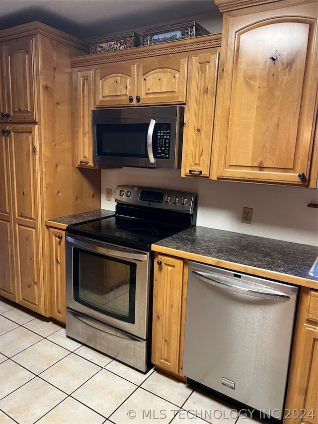 kitchen with stainless steel appliances and light tile patterned floors